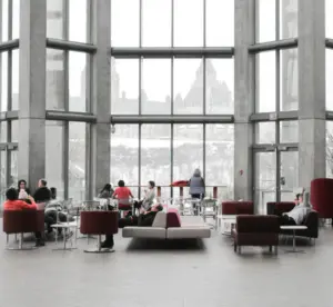 large lobby with eight people sitting in different areas